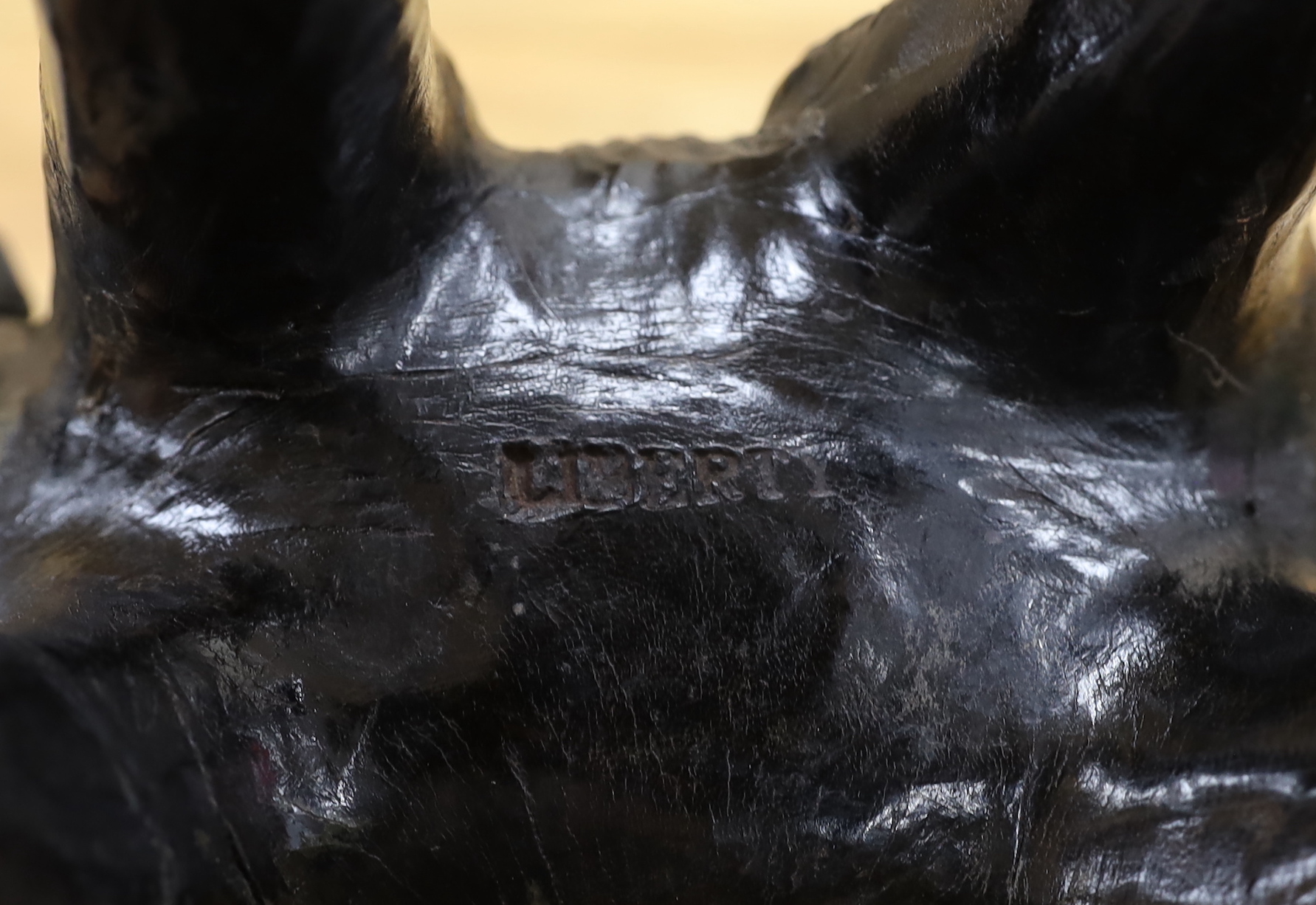A leather elephant, stamped Liberty to the underside, 30cm wide